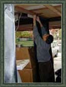 Victor hangs a length of fabric